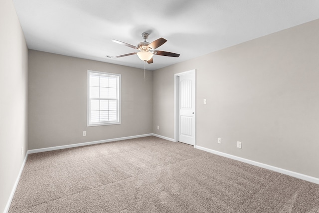 carpeted spare room featuring ceiling fan