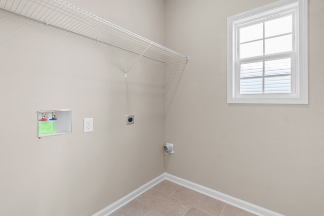 laundry room featuring electric dryer hookup, light tile patterned floors, and hookup for a washing machine