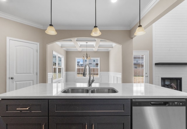 kitchen featuring stainless steel dishwasher, pendant lighting, crown molding, and sink