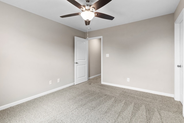 carpeted spare room featuring ceiling fan