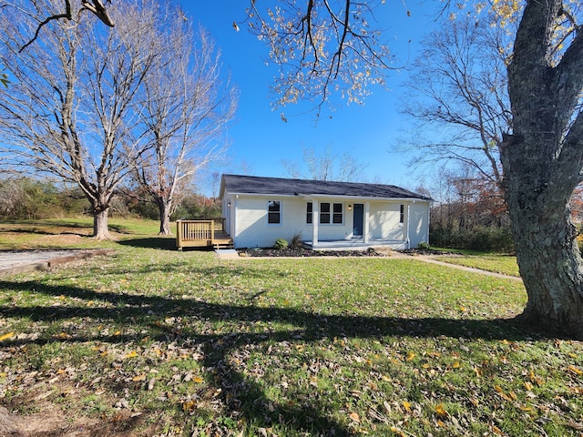 single story home featuring a deck and a front lawn