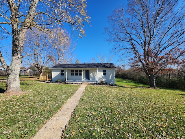 single story home featuring a front lawn