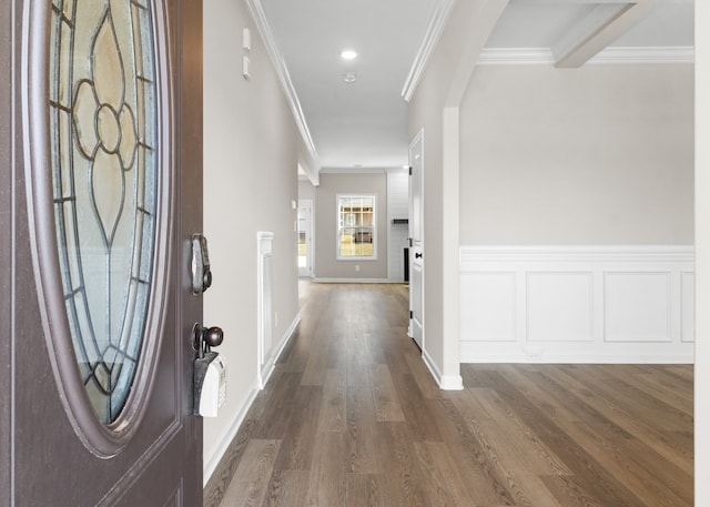 foyer entrance with dark hardwood / wood-style flooring and crown molding