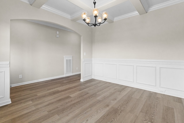 unfurnished dining area featuring hardwood / wood-style floors, crown molding, beamed ceiling, and a chandelier