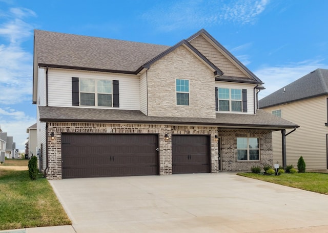 650 Woodrush Dr, Clarksville, TN 37040 - view of front of property with an attached garage, driveway, a shingled roof, brick siding, and stone siding