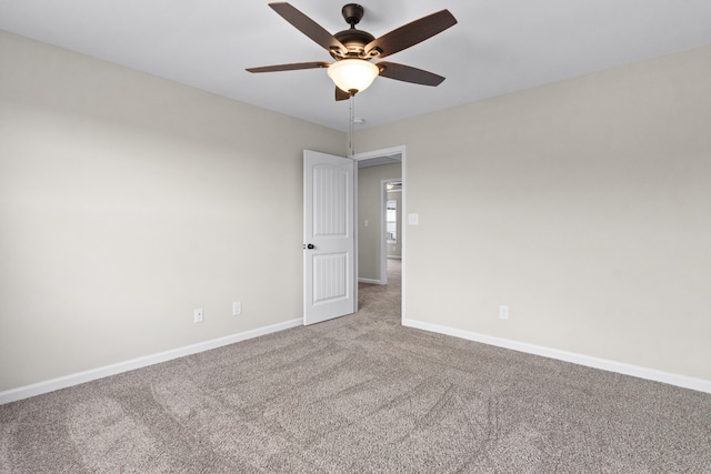 carpeted spare room with ceiling fan