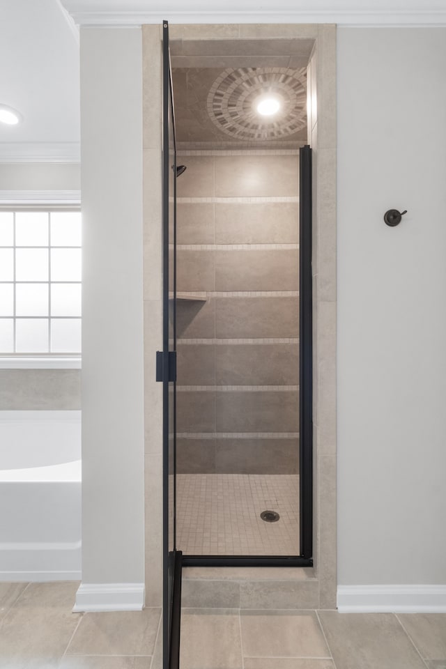 bathroom featuring separate shower and tub, tile patterned floors, and ornamental molding