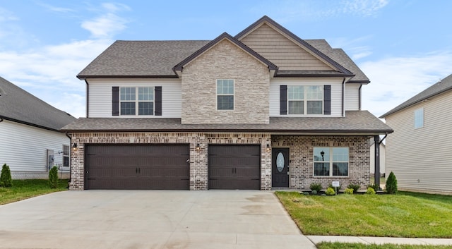 craftsman house with a front yard and a garage