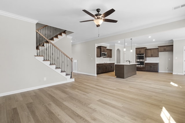 unfurnished living room with light hardwood / wood-style flooring, ceiling fan, and ornamental molding