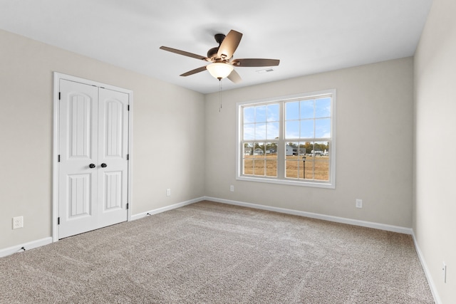 carpeted empty room with ceiling fan