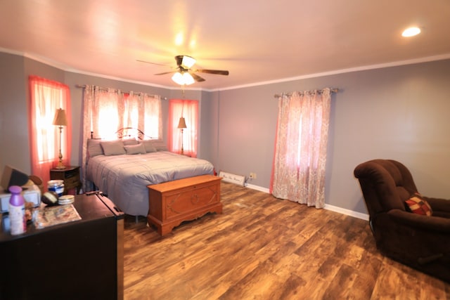 bedroom featuring ceiling fan, crown molding, and dark hardwood / wood-style floors