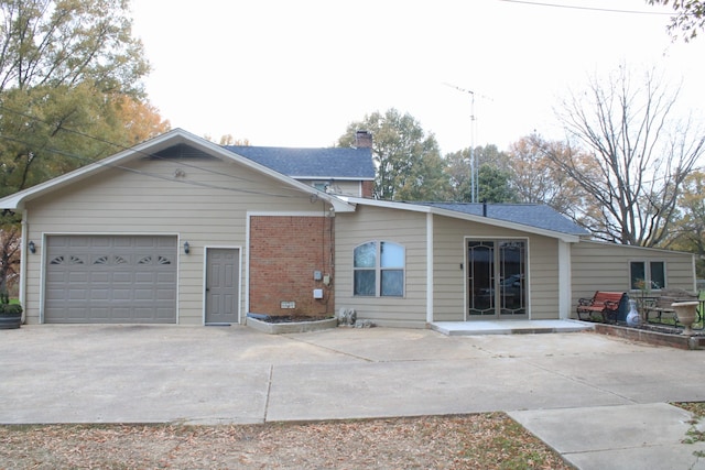 rear view of property featuring a garage