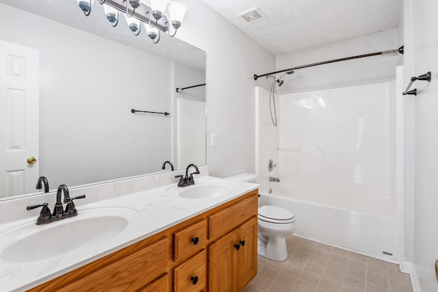 full bathroom with vanity,  shower combination, toilet, and a textured ceiling