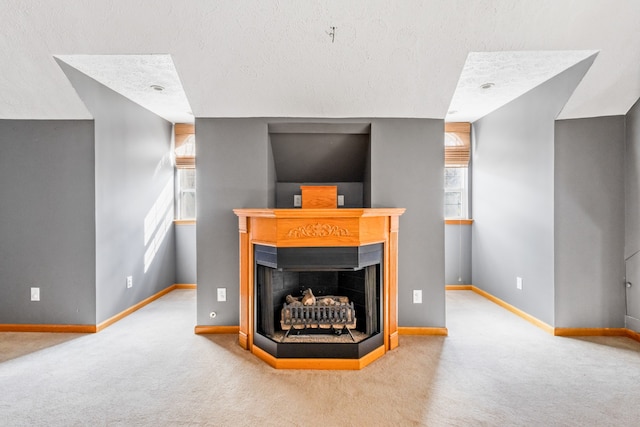 details with a multi sided fireplace, a textured ceiling, and carpet flooring