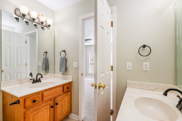 bathroom featuring a textured ceiling and vanity