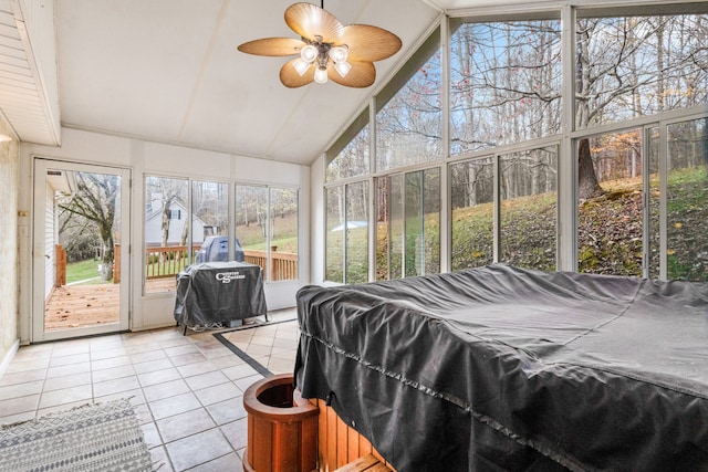 sunroom with vaulted ceiling, a wealth of natural light, and ceiling fan