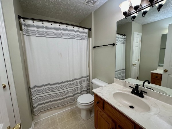 bathroom with vanity, a shower with curtain, a textured ceiling, and toilet