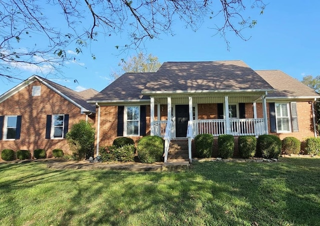 view of front of home with covered porch and a front lawn