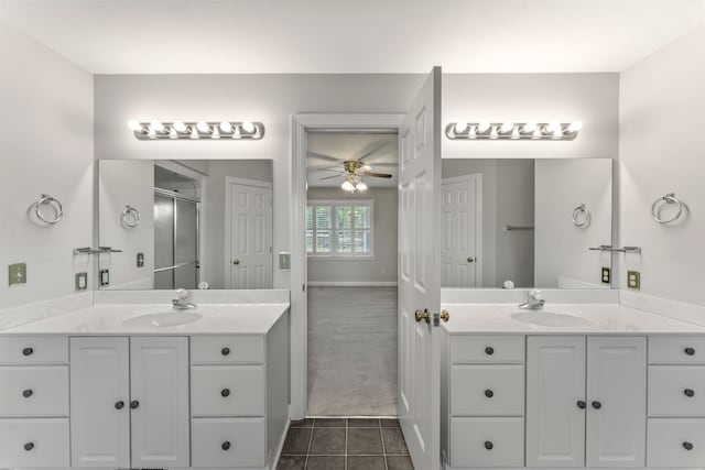 bathroom with tile patterned flooring, vanity, ceiling fan, and an enclosed shower