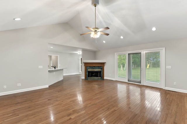 unfurnished living room featuring high vaulted ceiling, dark hardwood / wood-style floors, ceiling fan, and a high end fireplace