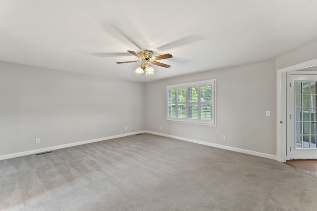 carpeted empty room featuring ceiling fan and a healthy amount of sunlight