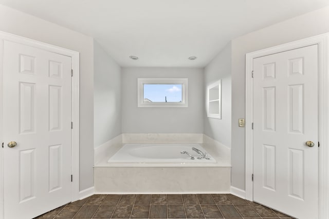 bathroom with tile patterned floors and a bathtub