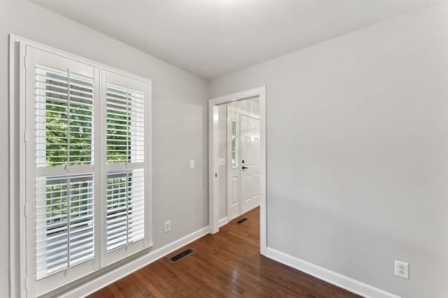 unfurnished room featuring dark hardwood / wood-style floors