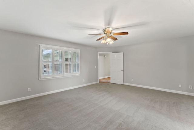 unfurnished room featuring ceiling fan and carpet floors