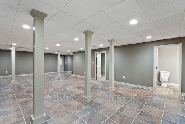 basement featuring tile patterned flooring and a drop ceiling