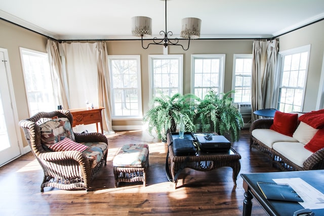 living room featuring wood-type flooring and an inviting chandelier