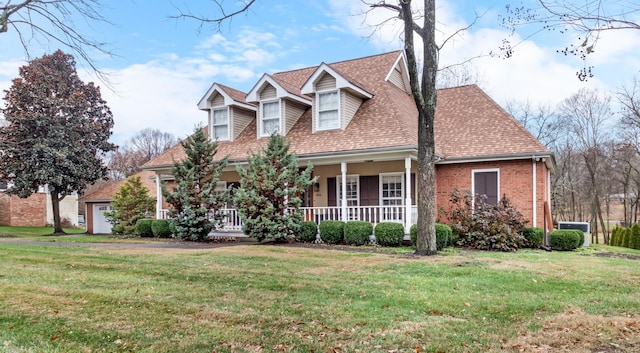 cape cod home featuring a front lawn and a porch