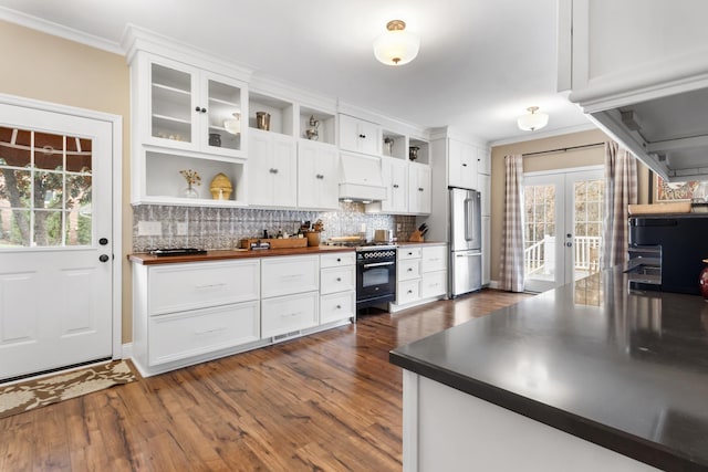 kitchen featuring a wealth of natural light, white cabinetry, and black range with gas cooktop