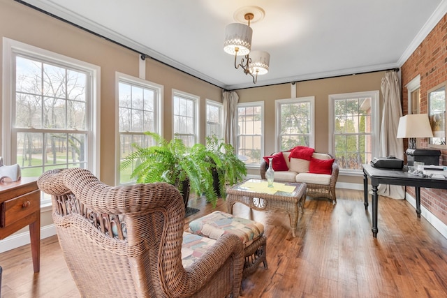 sunroom with a wealth of natural light and an inviting chandelier