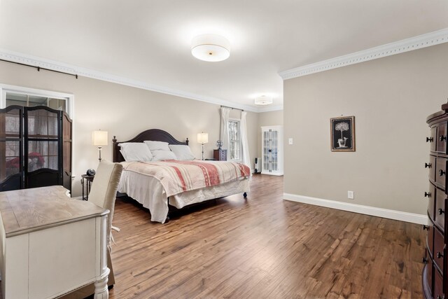 bedroom with ornamental molding and hardwood / wood-style flooring