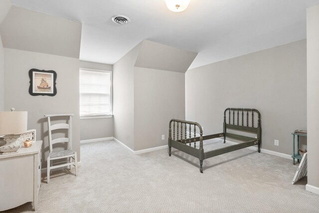 carpeted bedroom with vaulted ceiling