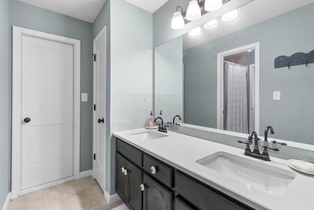 bathroom featuring tile patterned flooring and vanity