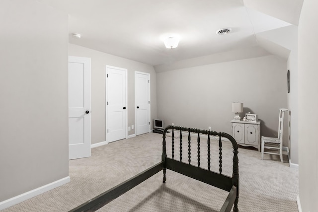 carpeted bedroom with lofted ceiling