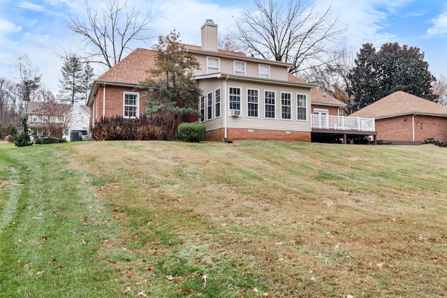 rear view of property with a yard and a wooden deck