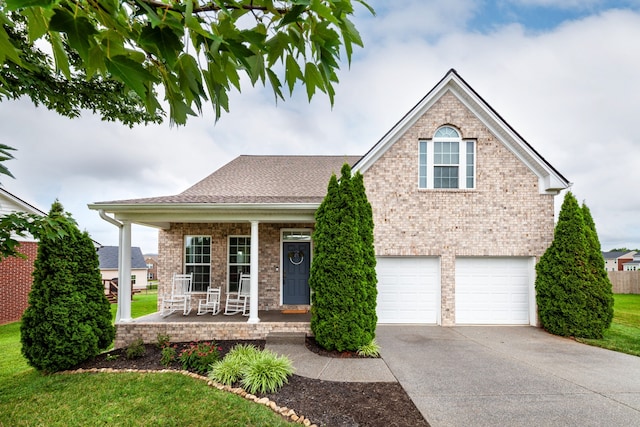 front of property featuring covered porch and a garage