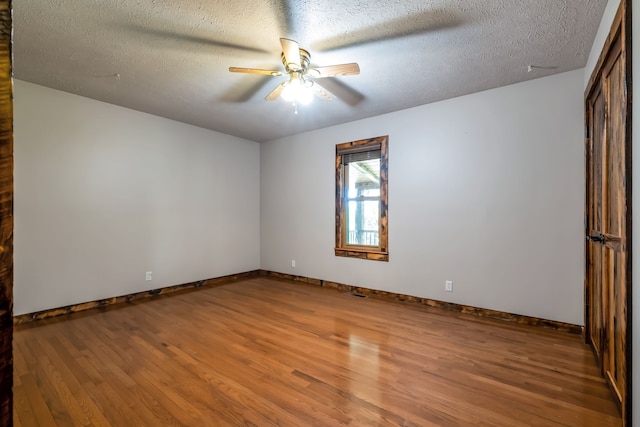 unfurnished room featuring ceiling fan, a textured ceiling, and hardwood / wood-style flooring