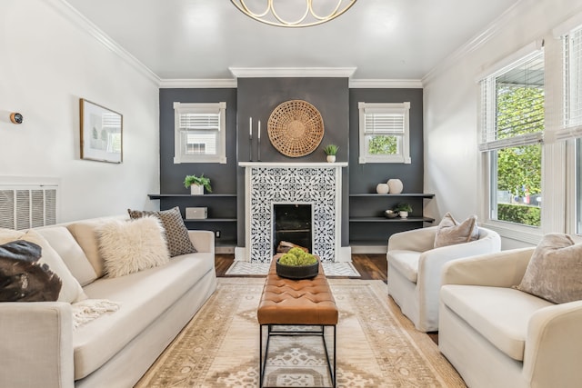 living room with light hardwood / wood-style floors, a wealth of natural light, and ornamental molding