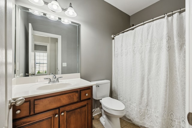 bathroom featuring tile patterned floors, vanity, and toilet