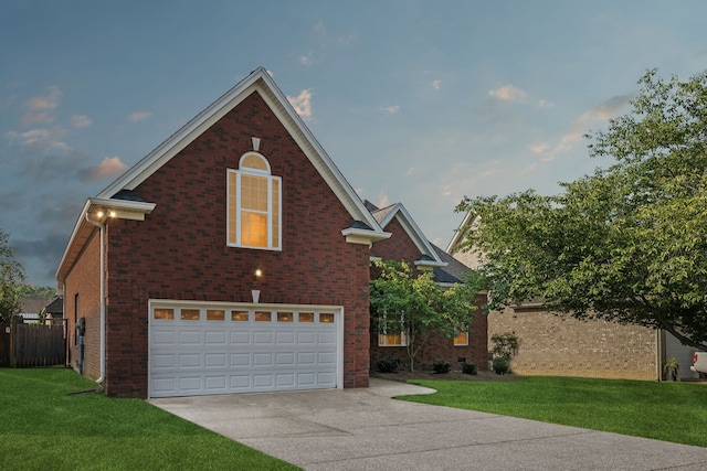 view of front of home featuring a front yard and a garage