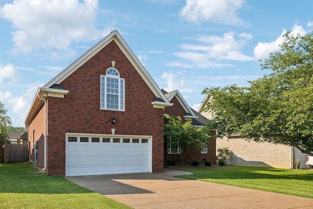 view of front of property with a front yard and a garage