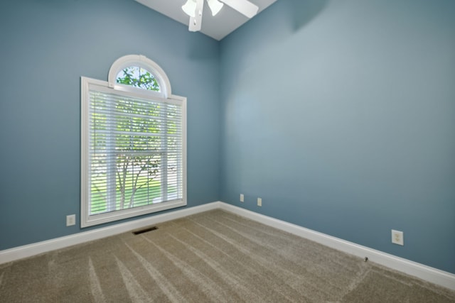 empty room with ceiling fan and carpet floors