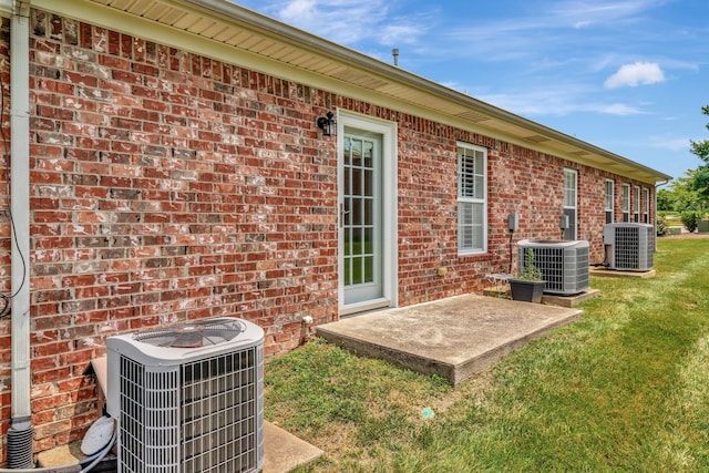 exterior space featuring central AC and a yard