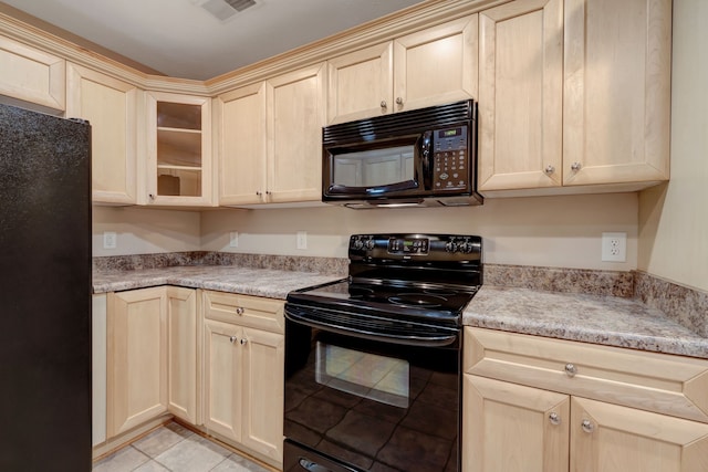 kitchen with light tile patterned floors and black appliances