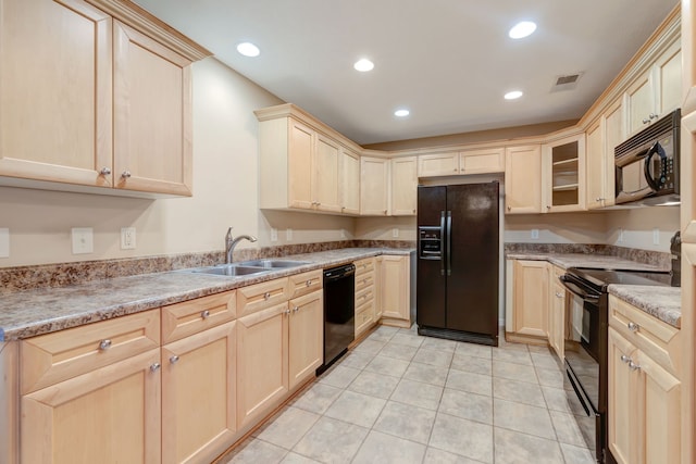 kitchen featuring light stone countertops, sink, black appliances, light tile patterned floors, and light brown cabinets