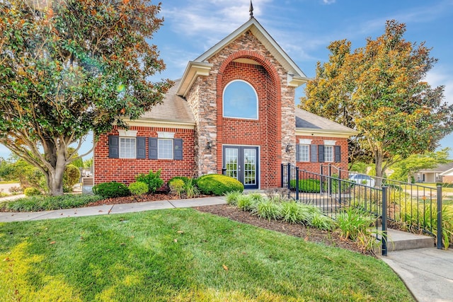 view of front facade with a front lawn and french doors