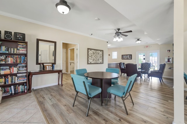 dining area with crown molding, light hardwood / wood-style flooring, ceiling fan, and french doors